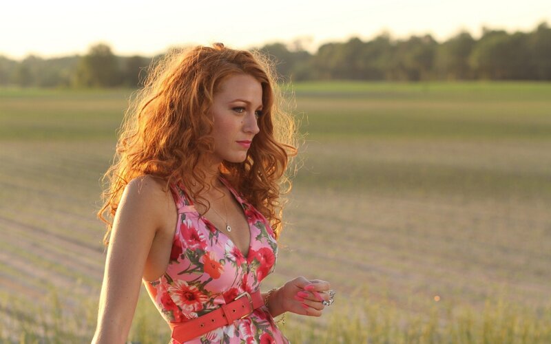 Woman in floral dress in field