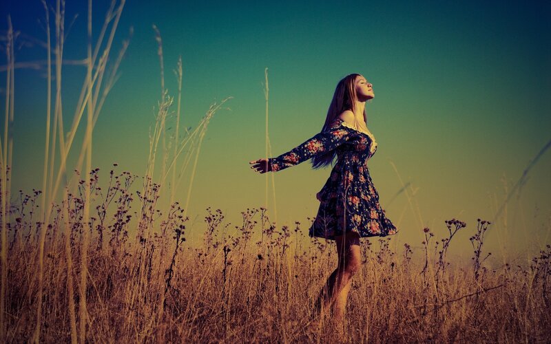 Woman in floral dress in field