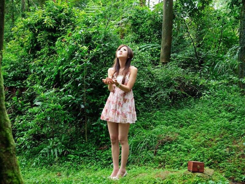Woman in floral dress in forest