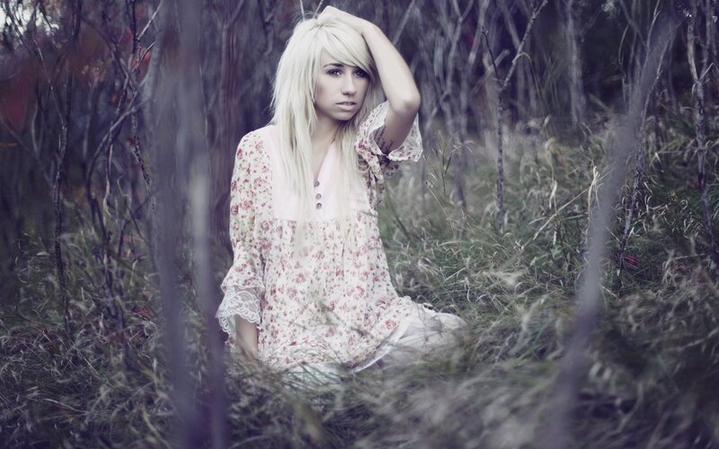 woman in floral dress in woods