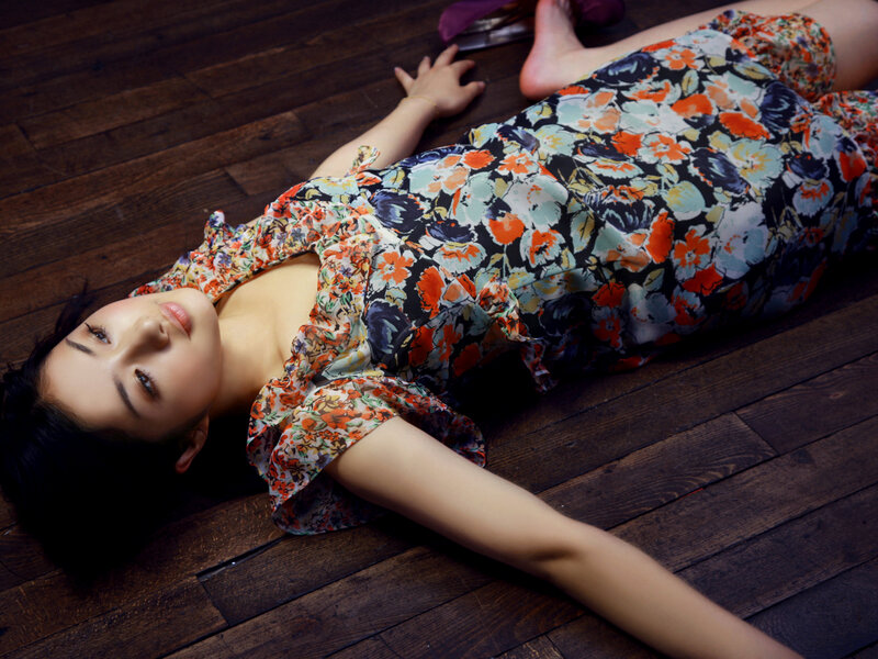 woman in floral dress lying on floor