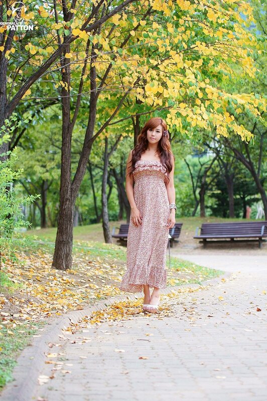 Woman in floral dress on autumn path