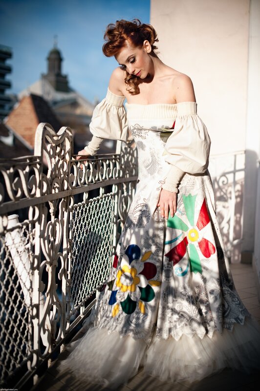Woman in floral dress on balcony