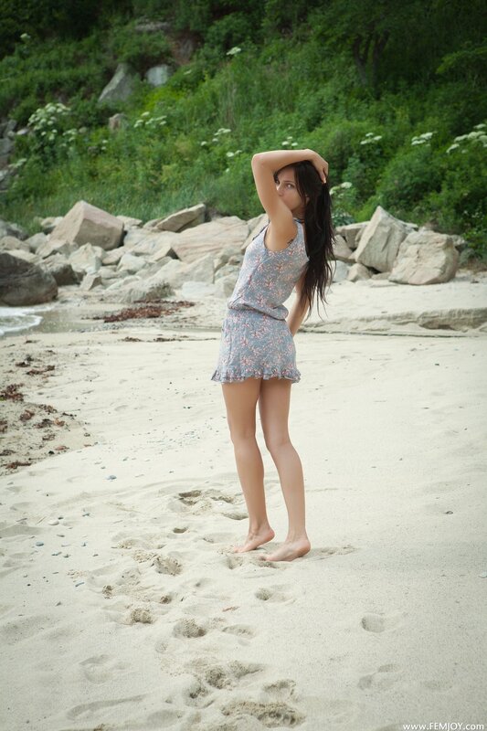 Woman in floral dress on beach