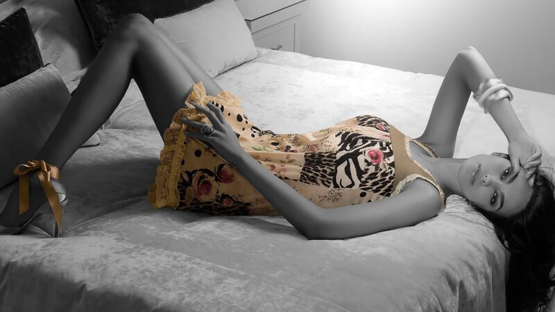 woman in floral dress on bed