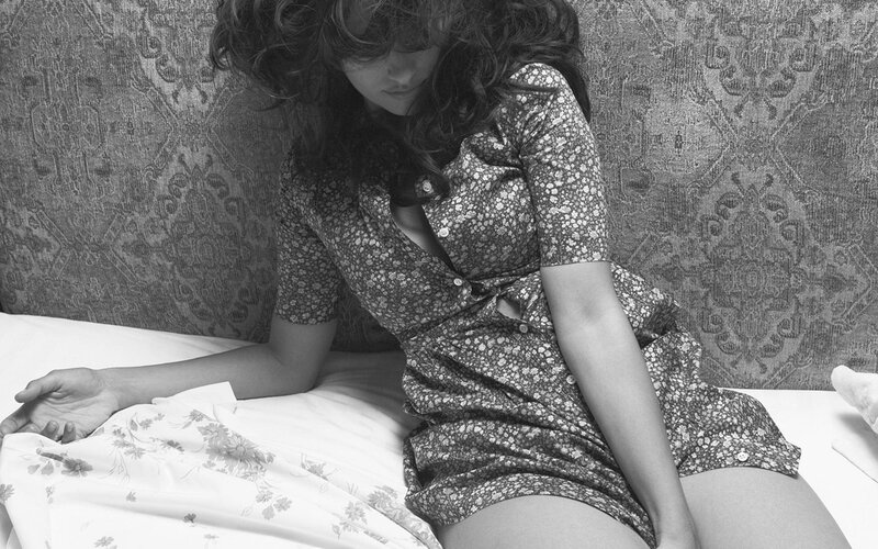 woman in floral dress on bed