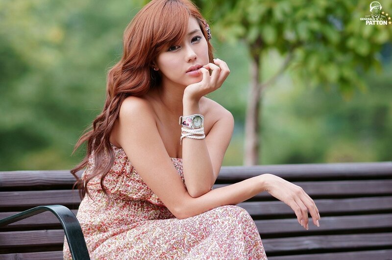 woman in floral dress on bench