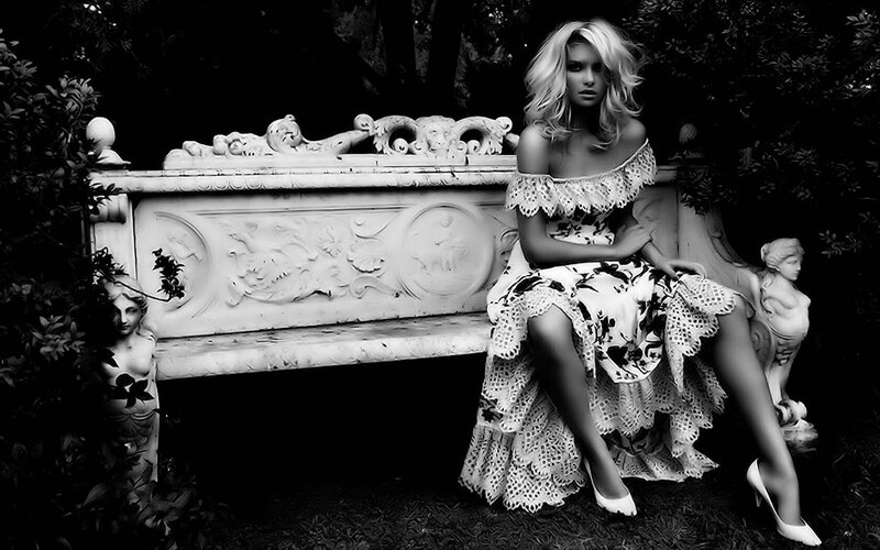 woman in floral dress on bench