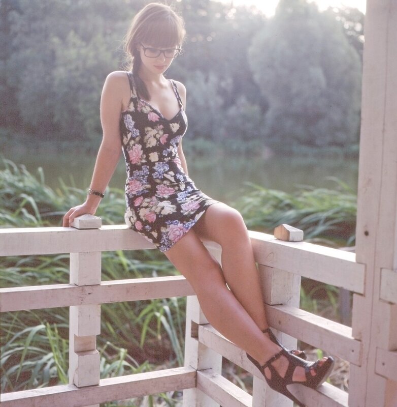 woman in floral dress on bridge