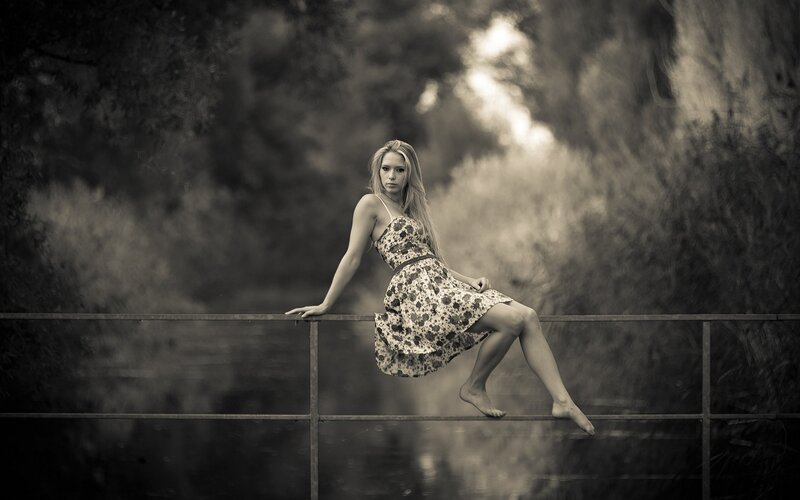 woman in floral dress on bridge