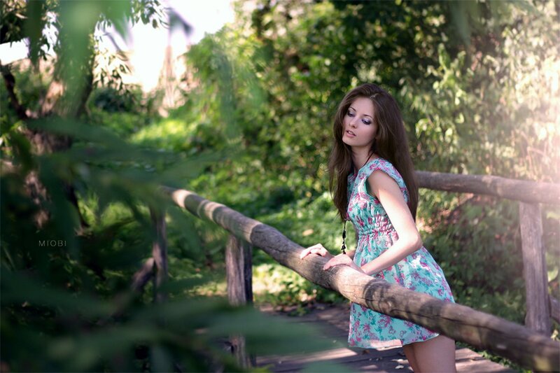 woman in floral dress on bridge