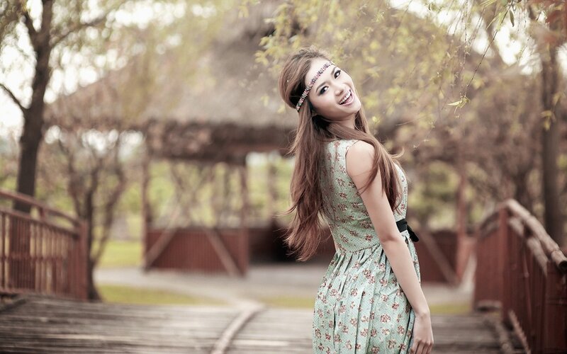 woman in floral dress on bridge