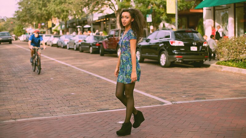 Woman in floral dress on city street