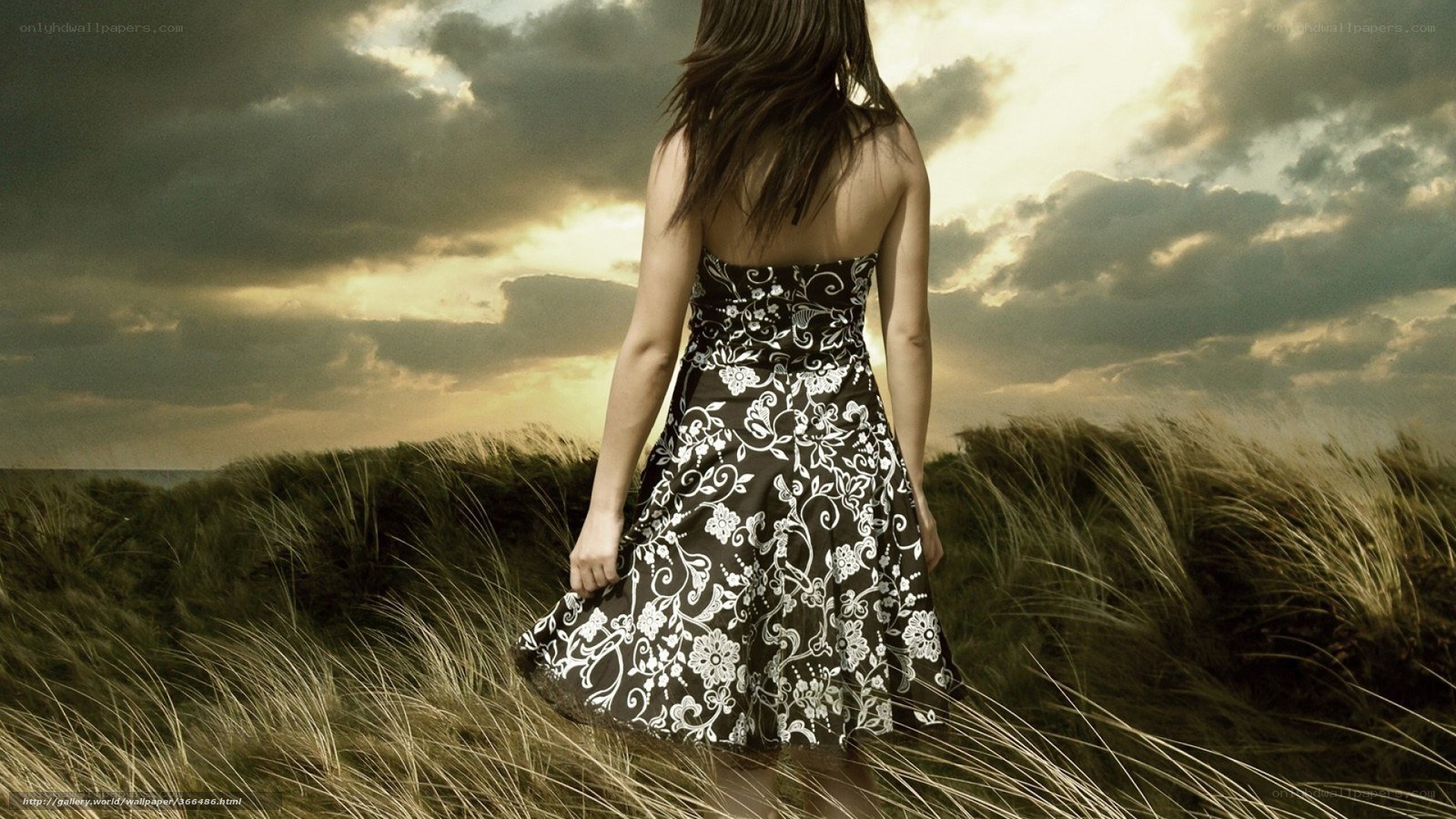 Woman in floral dress on dunes