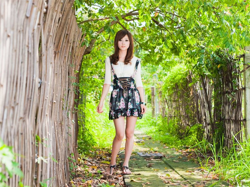 woman in floral dress on garden path