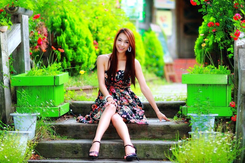 Woman in floral dress on garden steps