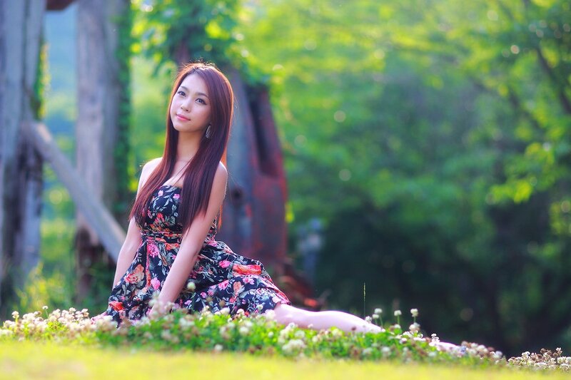 Woman in floral dress on grass