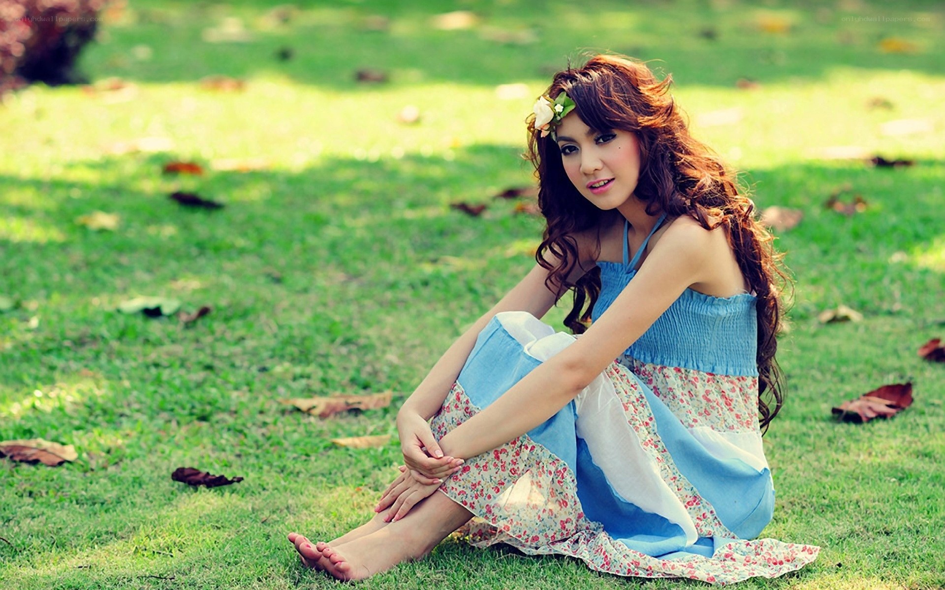 woman in floral dress on grass