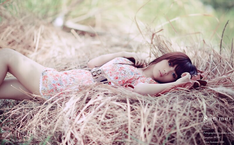 Woman in floral dress on hay