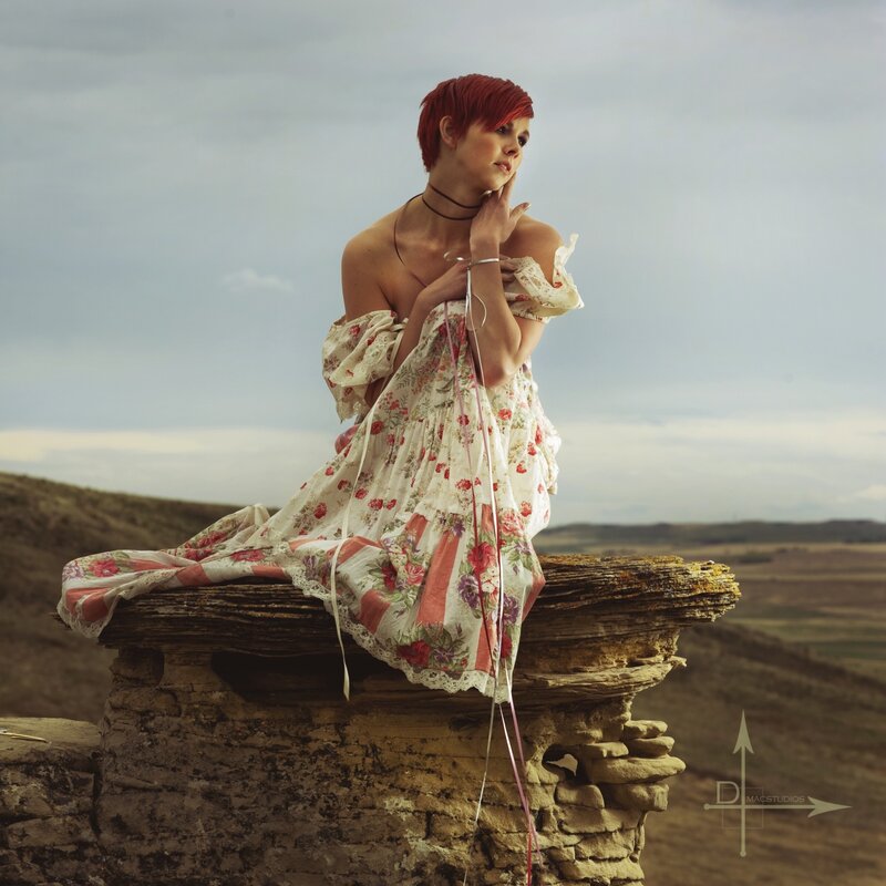 woman in floral dress on rock