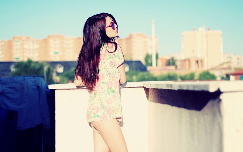 woman in floral dress on rooftop