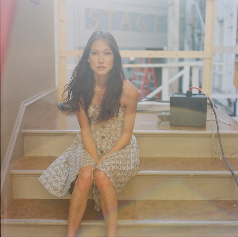 woman in floral dress on stairs