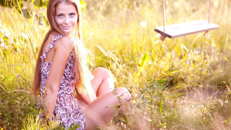 Woman in floral dress on swing
