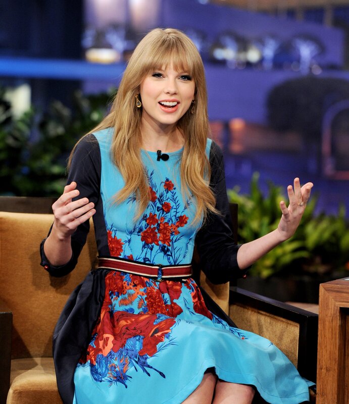 woman in floral dress on talk show