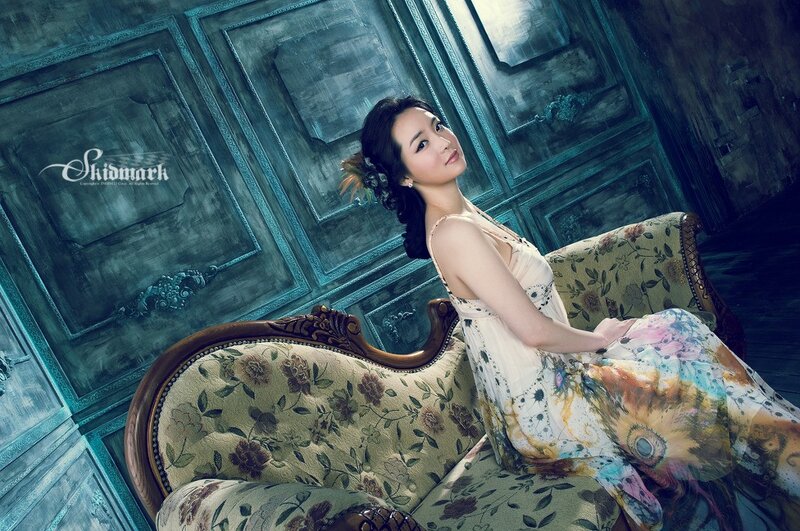 woman in floral dress on vintage sofa