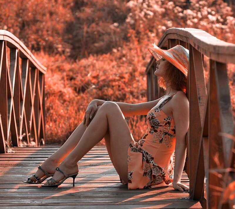 Woman in Floral Dress — Orange, Serene, Sunset