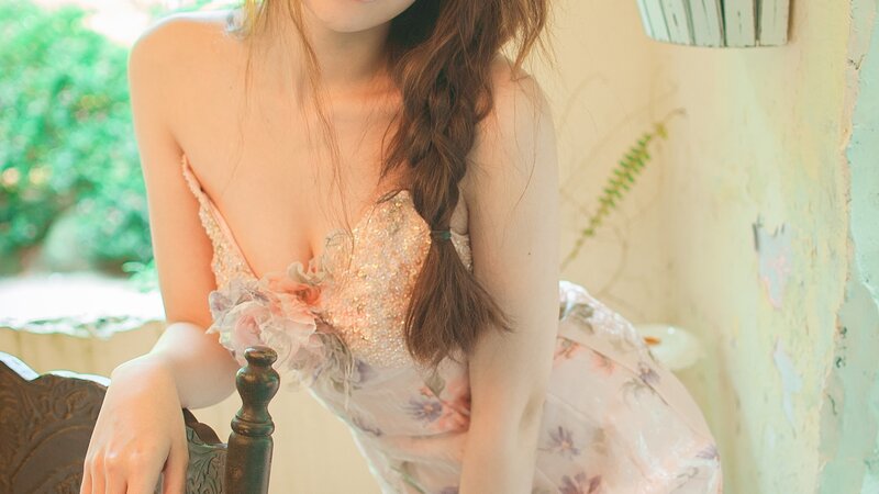 woman in floral dress sitting