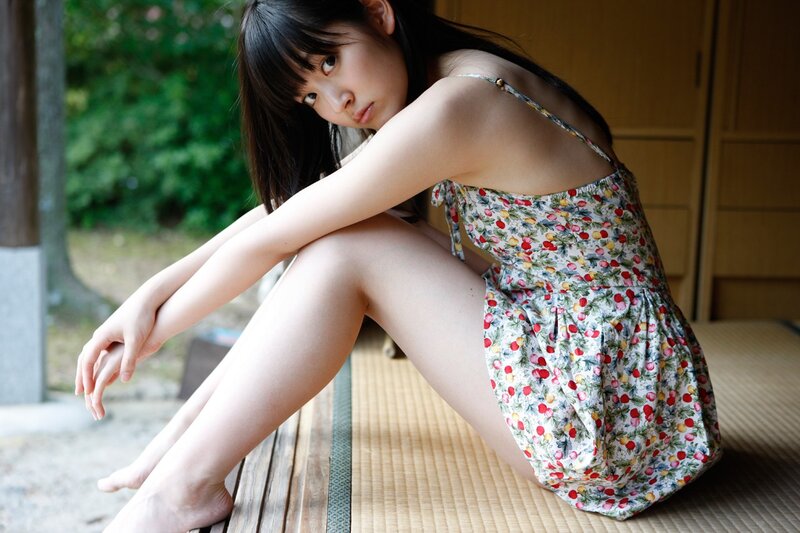 woman in floral dress sitting