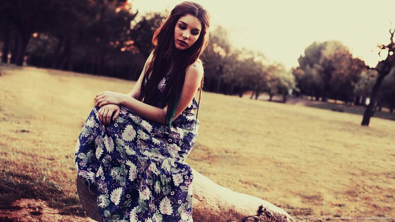 woman in floral dress sitting