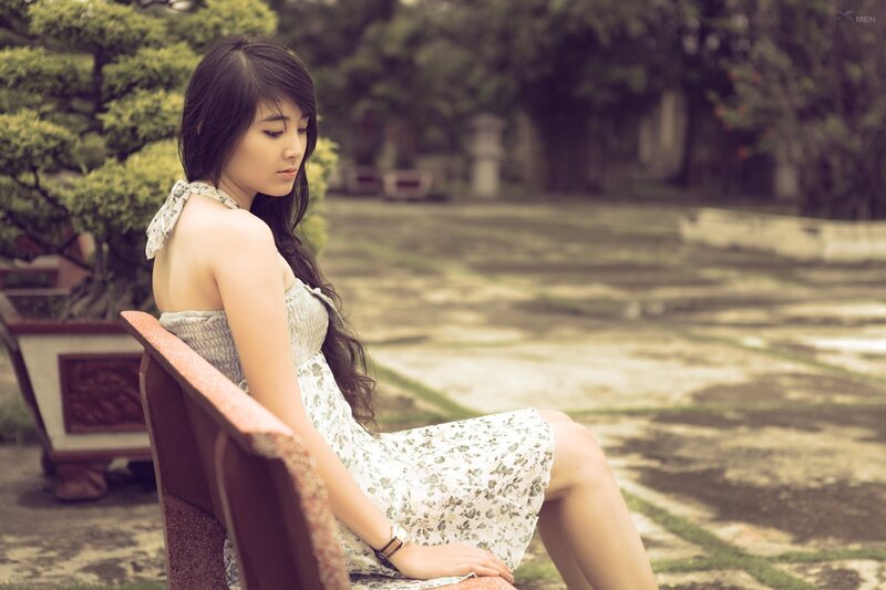 woman in floral dress sitting