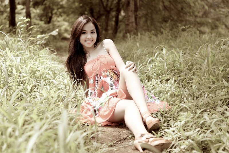 Woman in floral dress sitting in grass