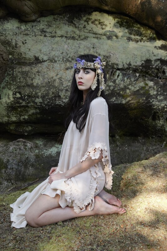 woman in floral dress sitting on rocks