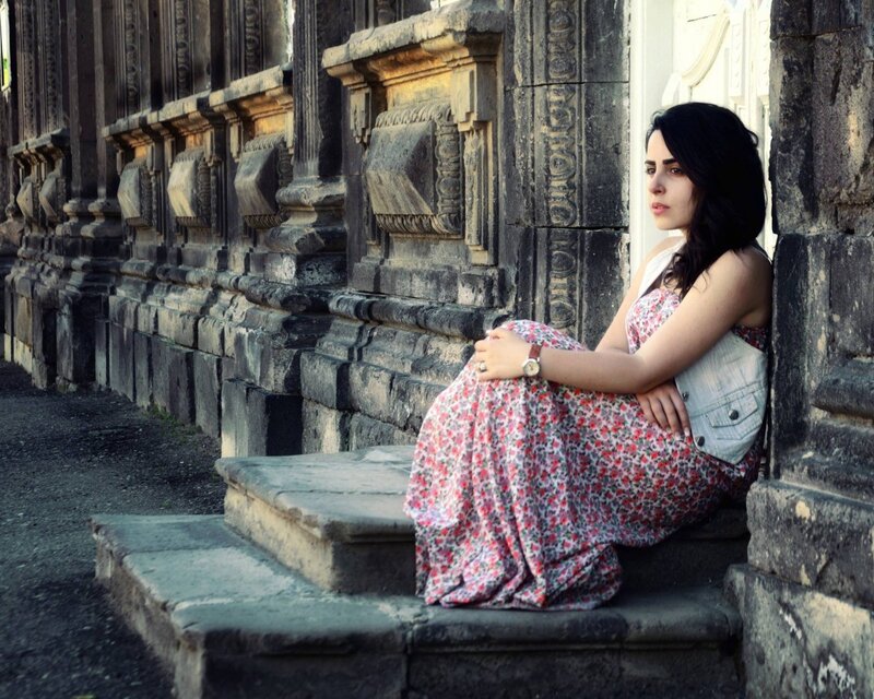 woman in floral dress sitting on steps