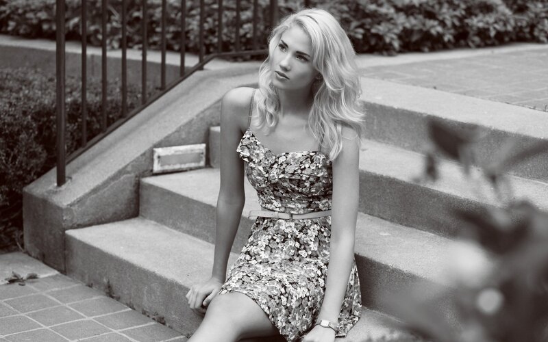 woman in floral dress sitting on steps