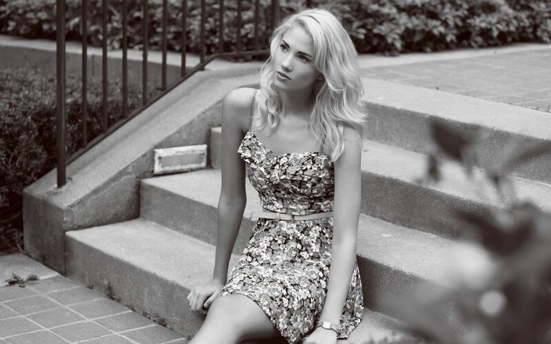 woman in floral dress sitting on steps