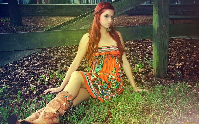 woman in floral dress sitting outdoors