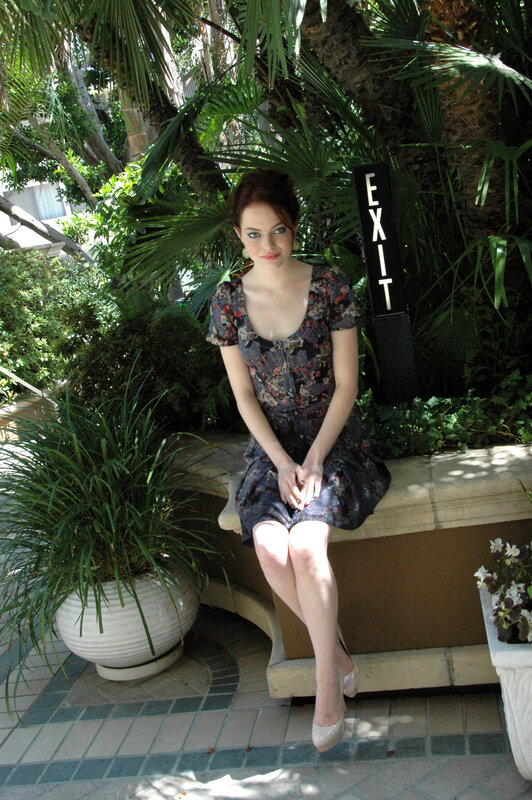 Woman in floral dress sitting outdoors