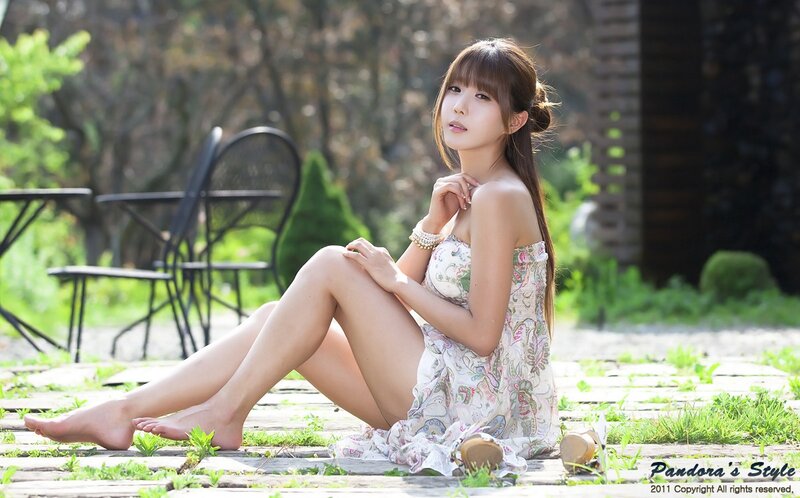 woman in floral dress sitting outdoors