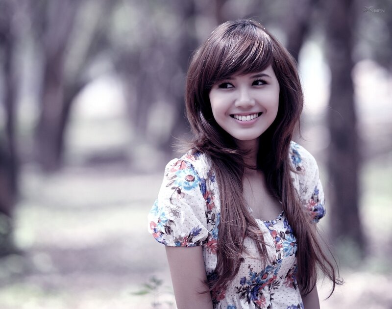 woman in floral dress smiling