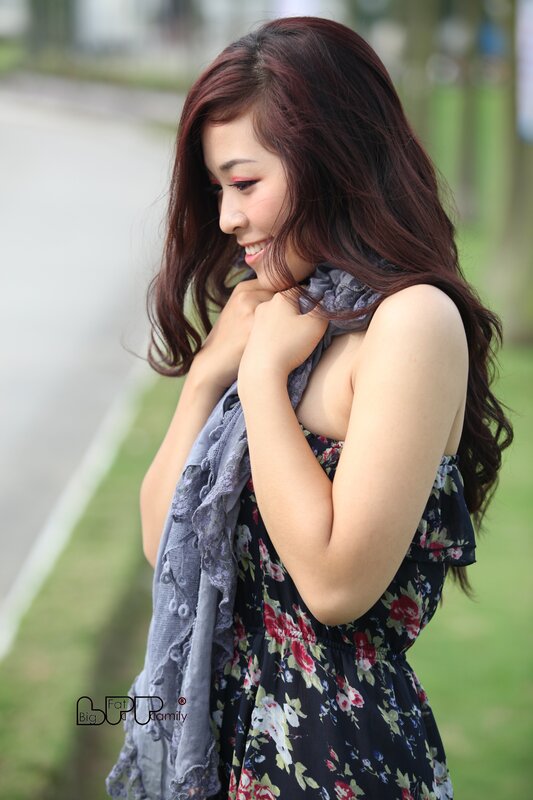 woman in floral dress smiling