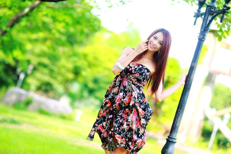 woman in floral dress smiling