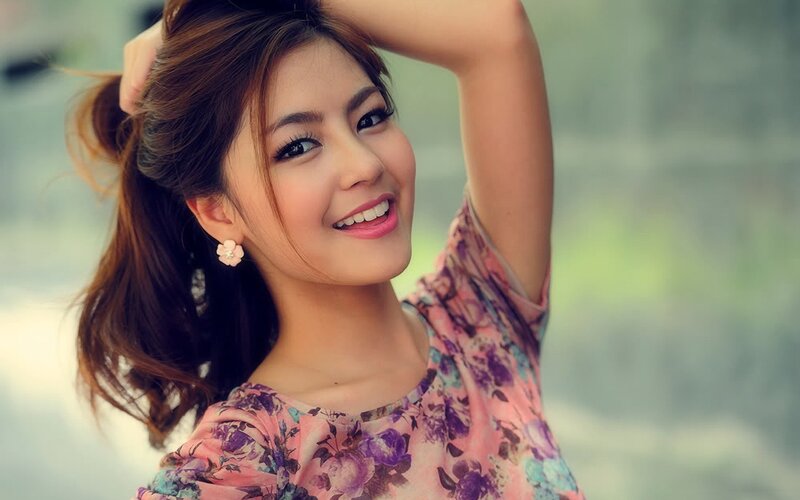 woman in floral dress smiling
