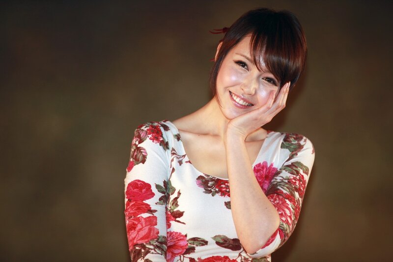 woman in floral dress smiling
