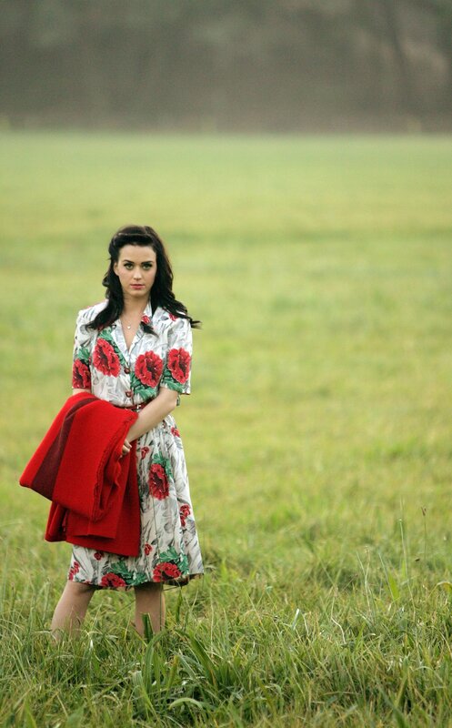 woman in floral dress standing in field
