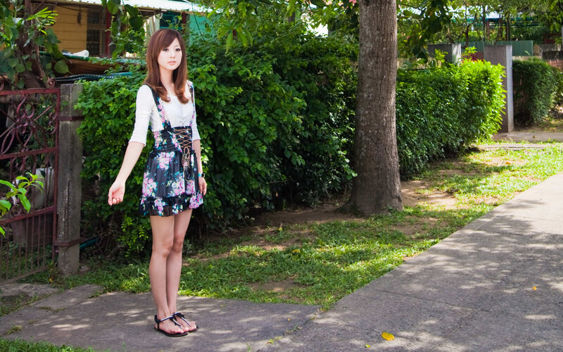woman in floral dress standing outside
