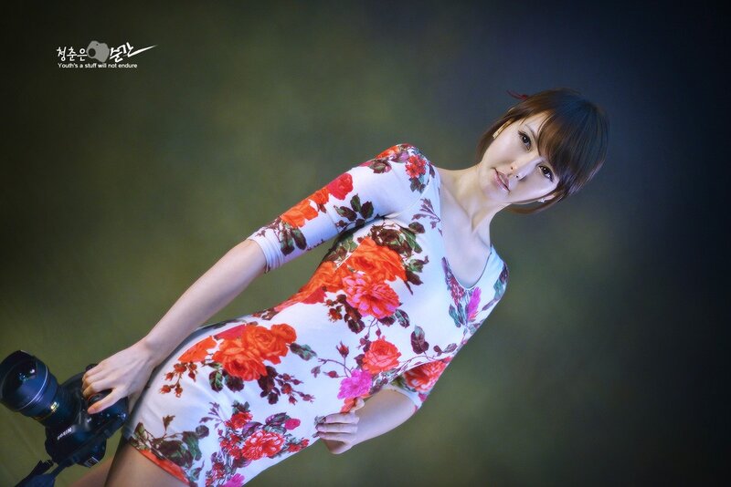 Woman in floral dress with camera